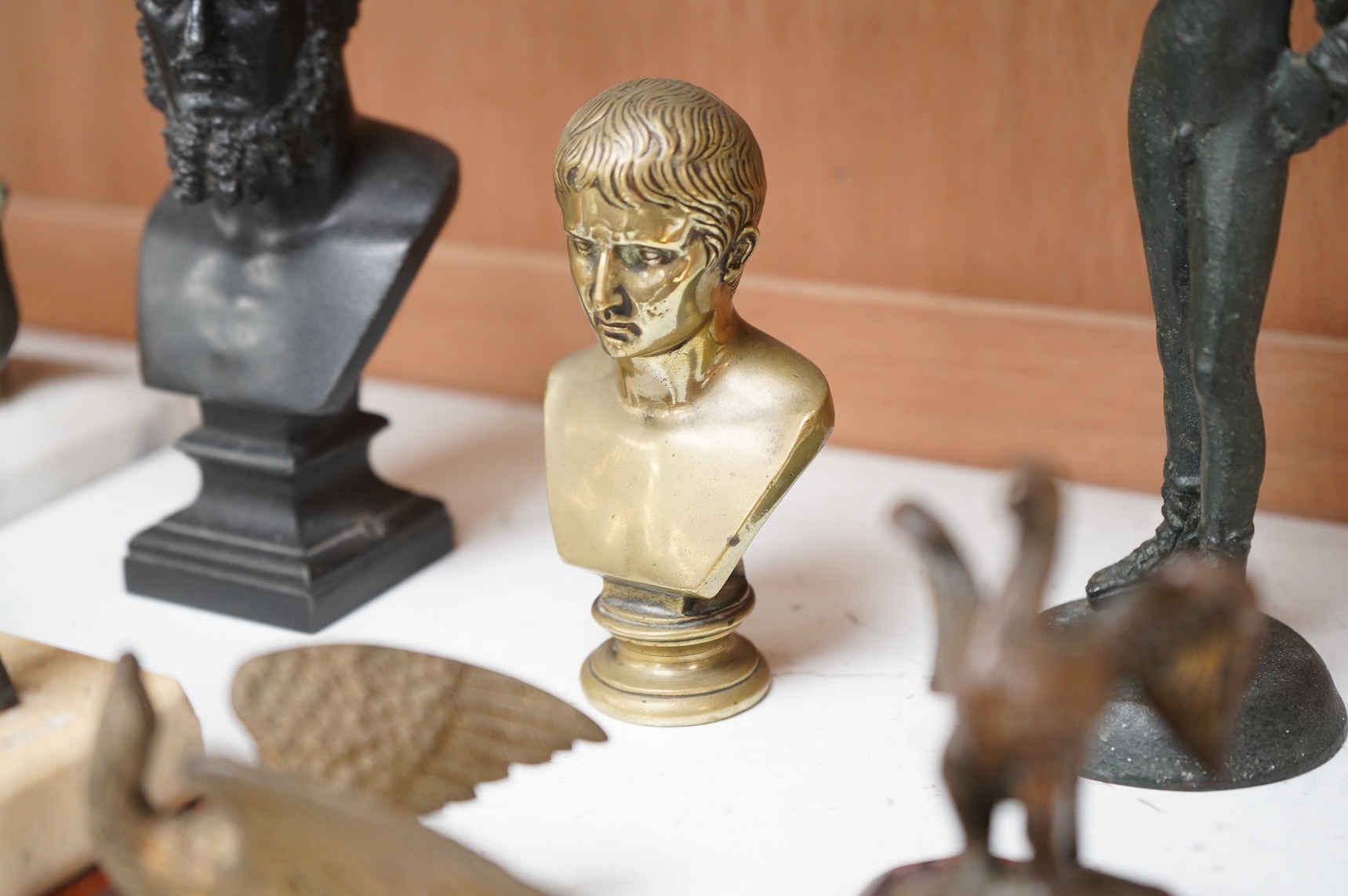 Italian grand tour souvenirs, 19th/20th century; nine small sculptures and busts, after the antique, the majority bronze and one depicting Lucius Verus, largest 19cm high